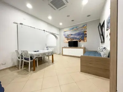 a dining room with a table and chairs in a room at Domus Rosaliae - Casa Vacanze in Palermo