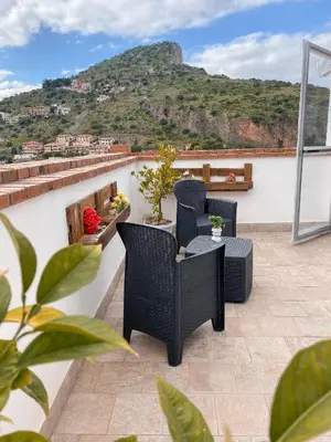 a room with two beds and a pendant light at il tramonto in Capaci