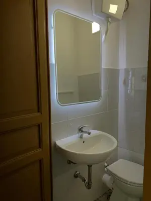a bathroom with a sink and a toilet and a mirror at Castello a Mare in Castellammare del Golfo