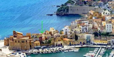 an aerial view of a city with boats in a harbor at Castello a Mare in Castellammare del Golfo
