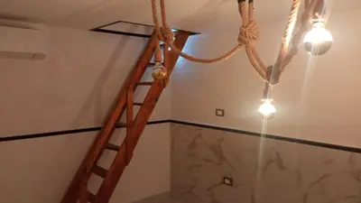 a wooden ladder in a room with a ceiling at Al Vicoletto Boutique in Castellammare del Golfo