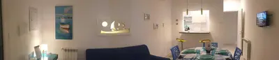 a dining room with a table and a blue chair at Mami Holiday House in Castellammare del Golfo