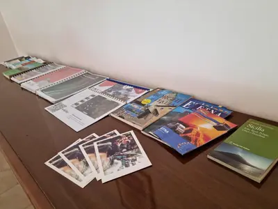 a table with a bunch of books on it at Casa di Mamma in Godrano