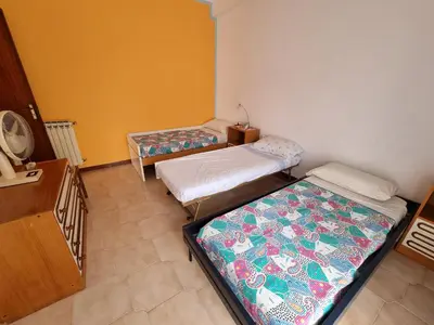a room with two beds in a room at Casa di Mamma in Godrano