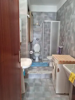 a bathroom with a shower and a toilet and a sink at Casa di Mamma in Godrano