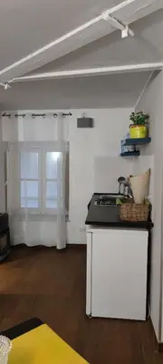 a kitchen with a stove and a counter top at Le Casette in Palermo