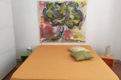 a bed in a room with a painting on the wall at VILLA CHIARA 200 MT DA MARE SPIAGGIA LIBERA SABBIA in Capaci