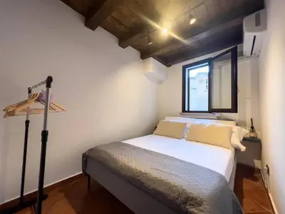 a small bedroom with a bed and a window at Domus Conte Federico in Palermo