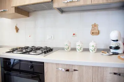 a kitchen counter with a stove top oven next to a counter top at CasaAntonietta in Alcamo