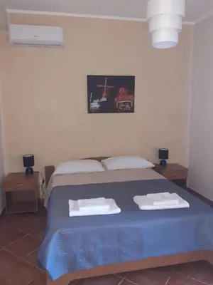 a bedroom with a blue bed with two towels on it at La Cycas in Trabia