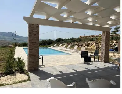 a pavilion with chairs and a swimming pool at Villa Mirò in Castellammare del Golfo