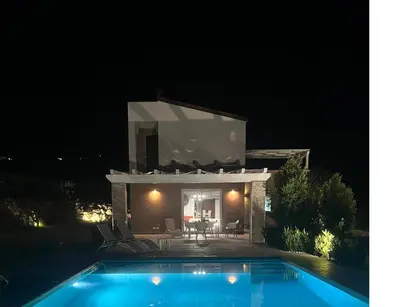 a villa with a swimming pool at night at Villa Mirò in Castellammare del Golfo