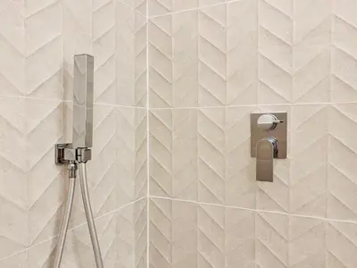 a shower in a bathroom with a tile wall at Villa di Nera Apartments in Palermo