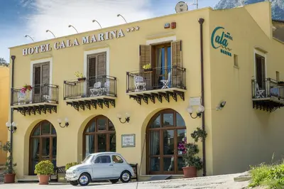 a small car parked in front of a building at Hotel Cala Marina in Castellammare del Golfo