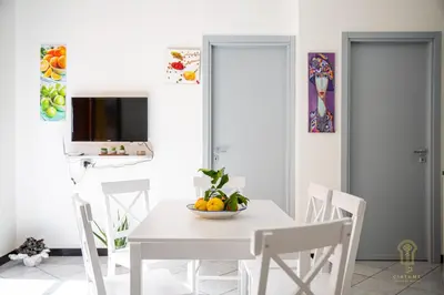 a white dining room with a white table and chairs at CIATU ME' Brezza Marina in Castellammare del Golfo