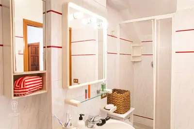 a bathroom with a sink and a mirror at CIATU ME' Brezza Marina in Castellammare del Golfo