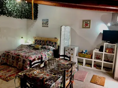 a bedroom with a bed and a table in it at Appartamento Green Room in Palermo