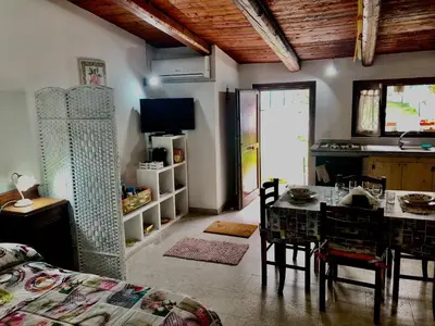 a kitchen and dining room with a table and a dining room at Appartamento Green Room in Palermo
