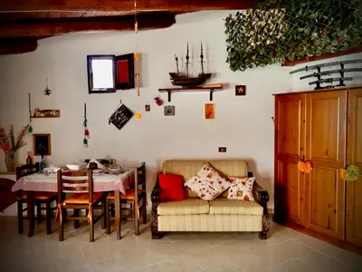 a dining room with a table and chairs at Appartamento Green Room in Palermo