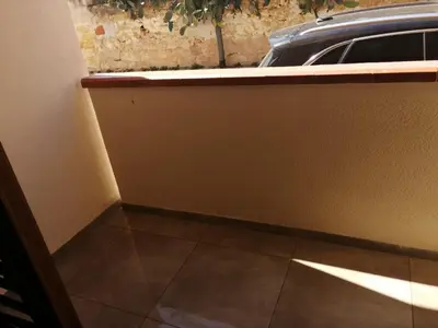 a corner of a room with a tiled floor at Appartamento Corallo in San Vito lo Capo