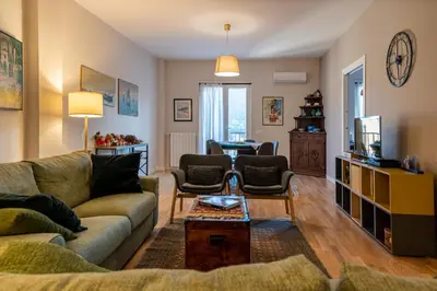 a living room with a couch and a table at La Paperella Blu Apartment in Termini Imerese