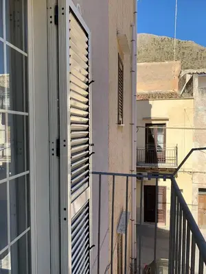 a balcony with a door and a window with a view at Casa Katrin & Casa Brigida in Castellammare del Golfo