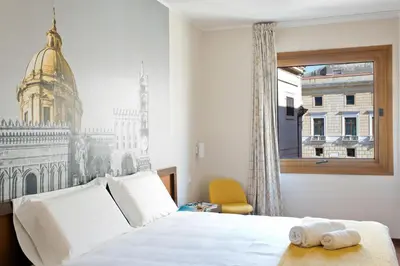 a hotel room with a bed and a window at B&B Hotel Palermo Quattro Canti in Palermo
