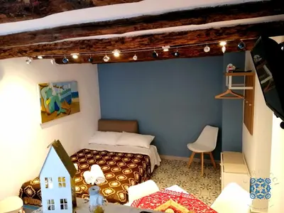 a doll house bedroom with a bed and a table at Carducci Loft in Castellammare del Golfo