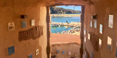 a view of a harbor from a building with a window at Carducci Loft in Castellammare del Golfo