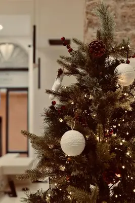 a christmas tree with ornaments on it at Palermo Inn Collection - Boutique Art Hotel in Palermo