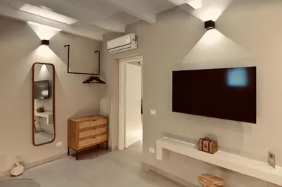 a living room with a flat screen tv on a wall at Palermo Inn Collection - Boutique Art Hotel in Palermo