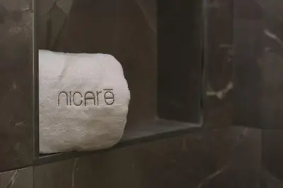 a towel with the word indore written on it in a bathroom at Nicarè City Apartments in Palermo