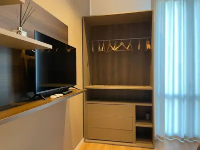 a living room with a tv and a curtain at Nicarè City Apartments in Palermo