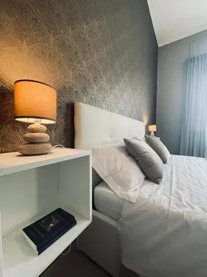 a bedroom with a bed and a table with a lamp at B&B Ungheria Ottantaquattro in Palermo