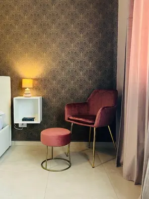 a room with two chairs and a table and a lamp at B&B Ungheria Ottantaquattro in Palermo