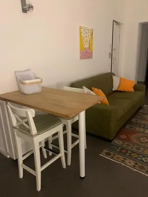a living room with a green couch and a table at La Casa di Giulia in Palermo