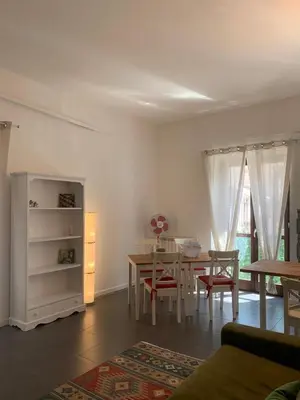 a living room with a table and a dining room at La Casa di Giulia in Palermo
