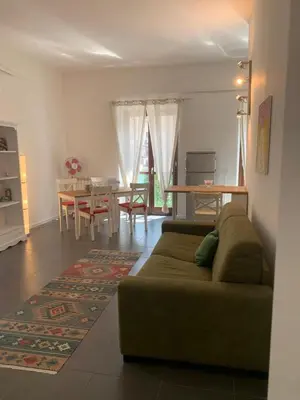 a living room with a table and chairs and a dining room at La Casa di Giulia in Palermo
