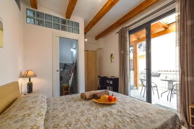 a bedroom with a bed with a plate of fruit on it at AMUNI' Apartments in Trabia