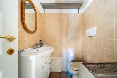 a bathroom with a sink and a mirror and a toilet at Attico nel cuore del centro storico di Palermo in Palermo