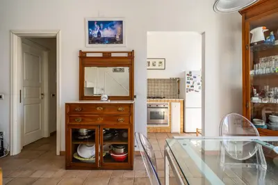 a kitchen with a wooden dresser with a mirror at Attico nel cuore del centro storico di Palermo in Palermo