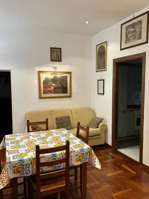 a living room with a table and a couch at toty alla guilla in Palermo