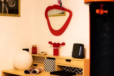 a room with a desk with a mirror on the wall at Art House Arenella con Terrazze by Wonderful Italy in Palermo
