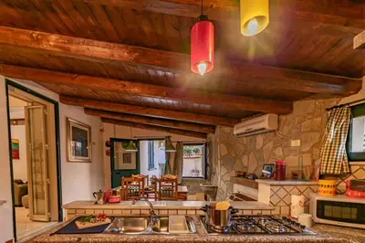 a kitchen with wooden ceilings and a stove top oven at Art House Arenella con Terrazze by Wonderful Italy in Palermo