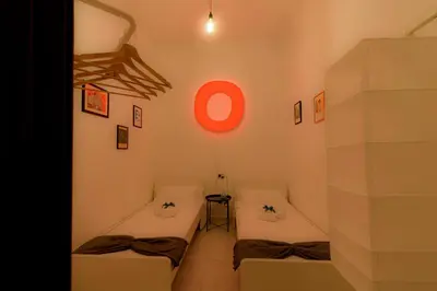 a room with two beds and a red circle on the wall at Art House Arenella con Terrazze by Wonderful Italy in Palermo
