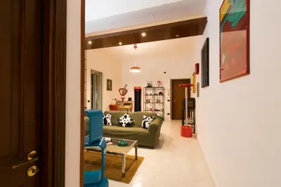 a living room with a couch and a table at Art House Arenella con Terrazze by Wonderful Italy in Palermo