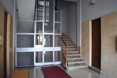 a staircase in a building with a door and a window at Casa Cavour in Palermo