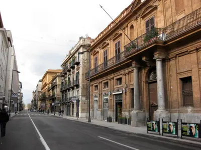 an empty street in a city with buildings at Casa Cavour in Palermo