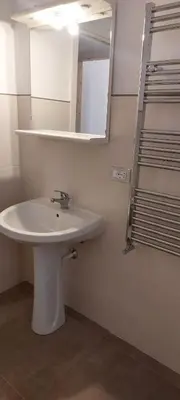 a bathroom with a white sink and a mirror at Silvia's House in Palermo