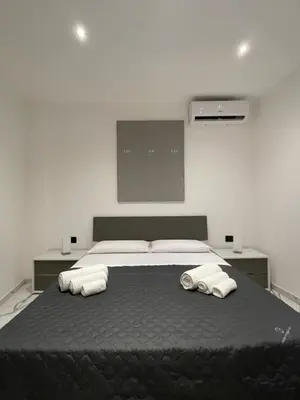 a bedroom with a large bed with two pillows at Casa vacanze donna Pina in Palermo